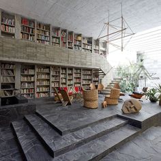 the interior of a library with stone steps leading up to it and bookshelves