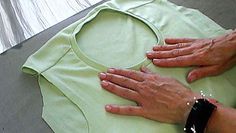 two hands that are on top of a green shirt