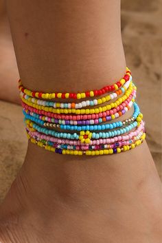 This multi-layered beaded anklet set features a beautiful yellow flower design with random color beads. Each layer adds depth and charm, making it the perfect accessory for any summer outfit. Handcrafted with precision and attention to detail, this anklet set is sure to make a statement. Beaded Anklet, Ankle Jewelry, Bright Eye, Tiny Beads, Bohemian Aesthetic, Color Beads, Plastic Crafts, Charm Making, Yellow Pattern