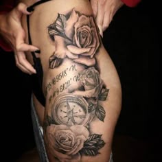 a woman is showing off her thigh with roses and an old pocket watch on it