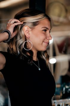 Add a touch of fun and flirtiness to your everyday look with our Zoe Brushed Hanging Hoop Earrings. These unique earrings feature a large hoop hanging from a smaller one, which gives it fun movement. They are perfect for adding a playful touch to any outfit! All of our jewelry is nickel free so you don't have to worry about that horrible nickel allergy! These brushed gold or silver earring pendants hang on 14k gold-filled or sterling hooks. Nickel Allergy, Flat Heel Boots, Diff Eyewear, Thermal Sweater, American Jeans, Beanie Style, Swim Accessories, Active Wear Leggings, Silver Earring