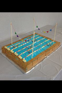 a cake that is sitting on top of a table with flags sticking out of it