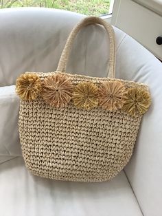 a straw bag sitting on top of a white couch