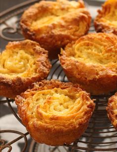 there are many small pastries on the wire rack, ready to be eaten and served