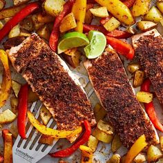 two fish fillets with peppers and potatoes on a plate