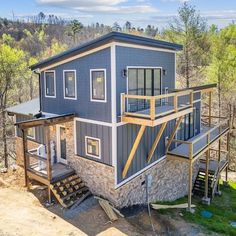 this is an aerial view of a house in the woods with stairs leading up to it