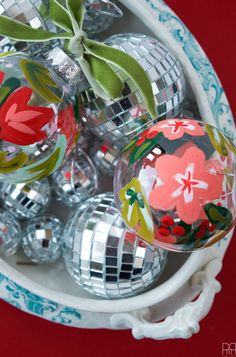 an arrangement of glass ornaments in a bowl