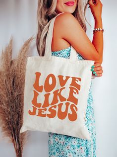 "This 100% cotton canvas tote bag features a retro design & the sweet words \"love like Jesus\". Perfect for the farmers market, groceries, books, gifts & so much more. 🙌🏼 DETAILS 🌼 -- 100% cotton sheeting -- Direct to garment printed design -- Reinforced handle stitching for durability -- Bag size: 15\"h x 16\"w -- Handle: 20\"" Everyday Retro Canvas Bag With Letter Print, Retro Everyday Canvas Bag With Letter Print, Retro Canvas Bag As A Gift, Retro Cotton Bag As Gift, Christian Tote Bag Design, Diy Canvas Bag, Jesus Tote Bag, Bible Tote Bag, Christian Tote Bags