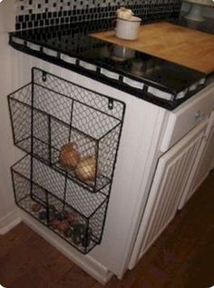 a kitchen counter with wire baskets on it