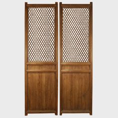 two wooden doors with lattice designs on them