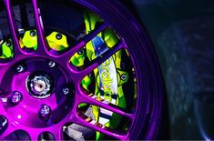 a purple wheel with yellow and green designs on the rim is seen in this image