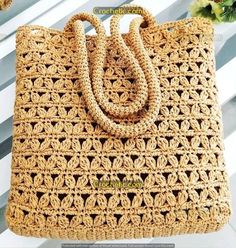 a crocheted handbag sitting on top of a table