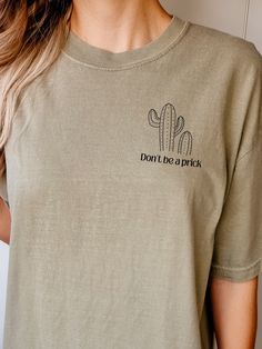 "Introducing our stylish and minimalist Don't Be a Prick Cactus Graphic Pocket Tee! This unisex T-shirt, made with premium Comfort Colors fabric, offers both comfort and durability.  Featuring a small and eye-catching cactus graphic on the left side pocket, this tee is perfect for those who appreciate minimalistic designs with a touch of humor. The text \"Don't Be a Prick\" adds a playful and witty element to the shirt, making it a conversation starter. Ideal for individuals who love expressing their unique style, this tee is perfect for casual outings, social media posts, or as a thoughtful gift for friends and loved ones.  Join the trend of embracing humor and minimalism with this must-have pocket tee. Order yours today and let the world know that you don't take life too seriously, but s Minimalist Crewneck, Inappropriate Shirts, Cactus Graphic, Bachelor Party Shirts, Volleyball Mom Shirts, Trending Graphic Tees, Cactus Shirt, Trendy Crewneck, Love Express