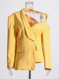 a mannequin wearing a yellow suit and jacket