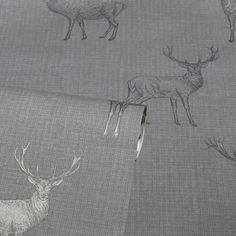 deer and elk on grey fabric with white outlined animals in the backgroung