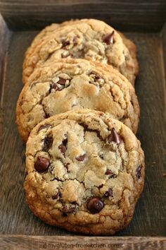 four chocolate chip cookies in a wooden box