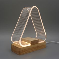 a lamp that is on top of a wooden block with a wire attached to it