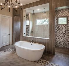 a bathroom with a large tub and chandelier