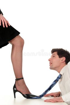 a woman is sitting on the ground with her feet up to a man's leg