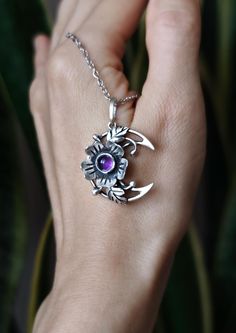 The Blooming Moon pendant is made entirely by hand in sterling silver with purple amethyst. It symbolizes an ode to life and femininity.  This wildflower Moon necklace is about women. They, like spring, harbor a bottomless creative power, giving life to new and beautiful things again and again. The Moon patronizes this power. The size of the pendant is about 0.98 х 1.02 inches (2.5 x 2.6 cm). This piece of jewelry is oxidized and polished. The price is for 1 pendant without the ring. You can find the matching ring from the photo here: https://jewelrybymirraling.etsy.com/listing/1051682918 Moon jewelry https://www.etsy.com/shop/JewelryByMirraling?ref=seller-platform-mcnav&sort_order=date_desc&search_query=moon Amethyst jewelry: https://www.etsy.com/shop/JewelryByMirraling?ref=seller-platfor Handmade Crescent Sterling Silver Jewelry, Symbolic Sterling Silver Jewelry With Natural Stones, Crescent-shaped Hallmarked Sterling Silver Jewelry, Crescent Hallmarked Sterling Silver Jewelry, Hallmarked Crescent Sterling Silver Jewelry, Bohemian Amethyst Moon Charm Jewelry, Handmade Moon Shaped Amethyst Jewelry, Mystical Silver Amethyst Necklaces, Handmade Purple Moon-shaped Jewelry