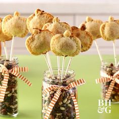 cookies and nuts are arranged in glass jars with candy sticks sticking out of the top