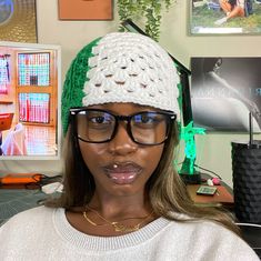 a woman wearing glasses and a knitted hat