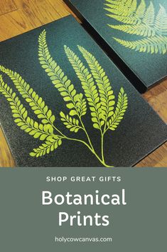 two green leaves on black mats with the words shop great gifts botanical prints