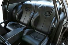 the interior of a car with black leather seats