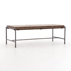 a wooden table sitting on top of a metal frame