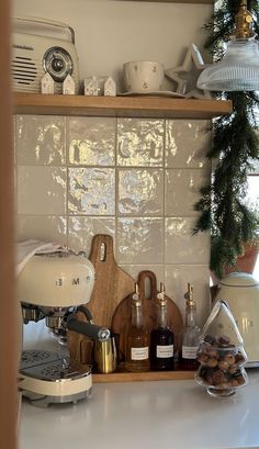 the kitchen counter is cluttered with coffee, cookies, and other condiments