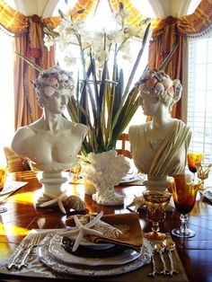 there are two statues on the dining room table