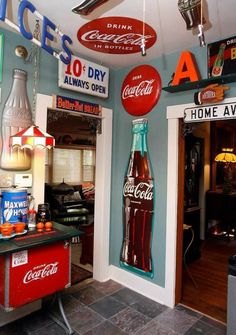 the inside of a soda shop with many signs on the wall