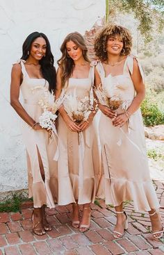 three beautiful women standing next to each other