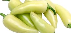 several yellow peppers are stacked on top of each other