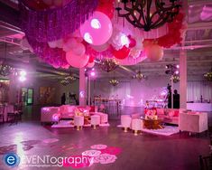 a room filled with pink couches and balloons