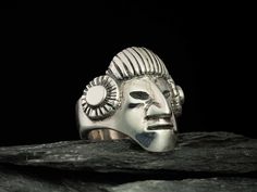 This ring absolutely hand made, first of all it sculpting by hand without any 3D or computer program. After it is founding, polishing and oxidized only by hands. weight is about 25 grams Top width 1,06" (27 mm) Immerse yourself in the ancient culture with this unique handmade silver ring in the shape of an Inca warrior mask. Meticulously crafted with love and attention to detail, this ring is a stunning blend of artistry and history. Each ring is carefully made from high-quality silver to captur Inca Warrior, Warrior Mask, Warrior Ring, Silver Mask, Steam Punk Jewelry, Aztec Art, Wooden Gift Boxes, Punk Jewelry, Skull Earrings