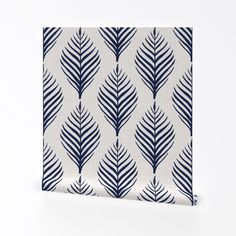 a blue and white leaf pattern on a canvas wall art print with dark blue accents