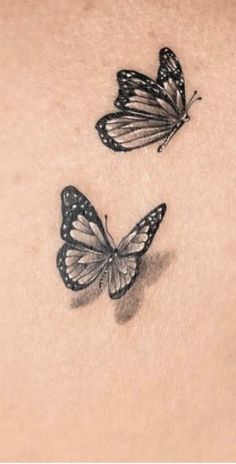 two butterflies on the back of a woman's stomach