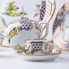 an assortment of porcelain tea cups and saucers