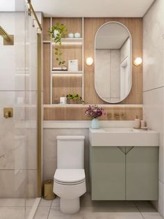 a white toilet sitting next to a bathroom sink under a round mirror on a wall