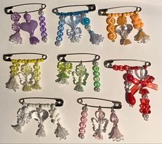 six different colored hair clips with bows and beads on them, all in various colors