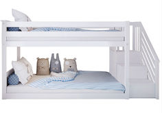 a white bunk bed with stuffed animals on it