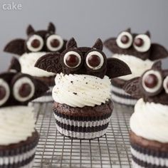 chocolate cupcakes with white frosting and eyes on cooling rack, ready to be eaten