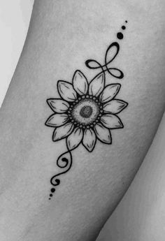 a black and white photo of a sunflower tattoo