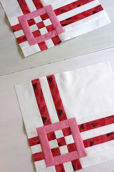 two pieces of paper with red and white strips on them