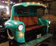 an old truck is being worked on in a garage