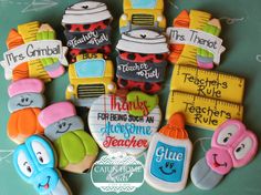 decorated cookies are arranged in the shape of school bus, ruler and cupcakes