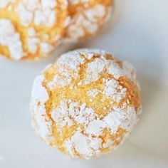 two powdered sugar cookies sitting on top of a white plate