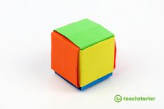 an orange, yellow and green cube sitting on top of a white surface with the words teachstarter below it