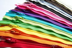 there are many colors of zippers on the table